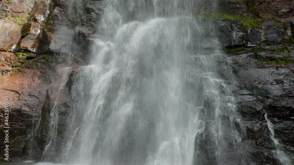 A medium shot waterfall flowing into a body of water A medium shot waterfall flowing into a body of water