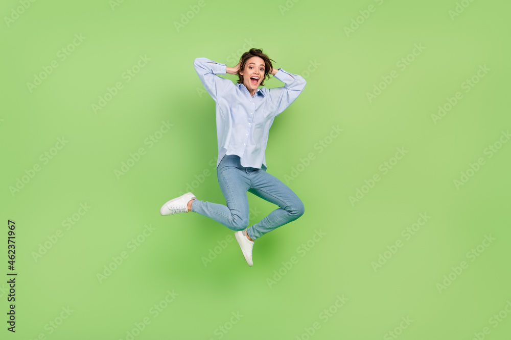 Full body photo of happy cheerful amazed shocked woman jump up hand head sale isolated on green color background