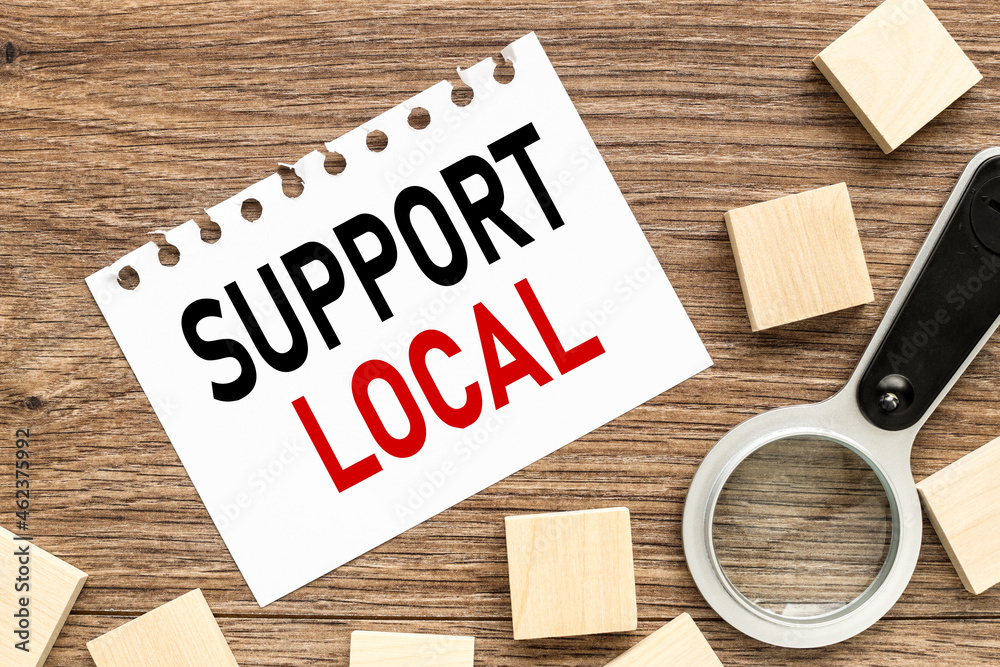Support local, white sheet of paper on a notebook. with place for text. wood blocks, financial planning and work concept. Support local, white sheet of paper on a notebook. with place for text. wood blocks, financial planning and work concept.