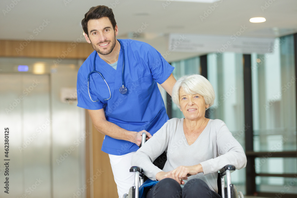 Fototapeta premium old woman with male nurse in hospital