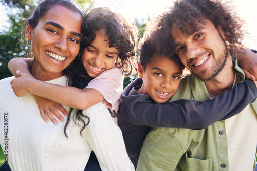 Portrait of family smiling towards camera