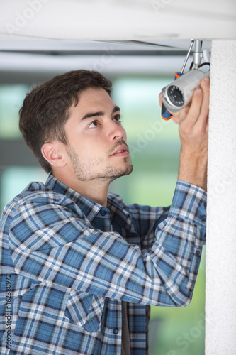 contractor installing surveillance cctv cameras in office