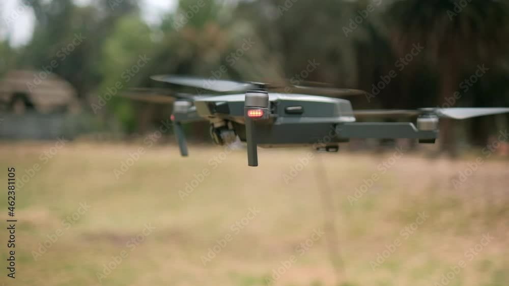 Drone flying low with blurry trees as background Drone flying low with blurry trees as background