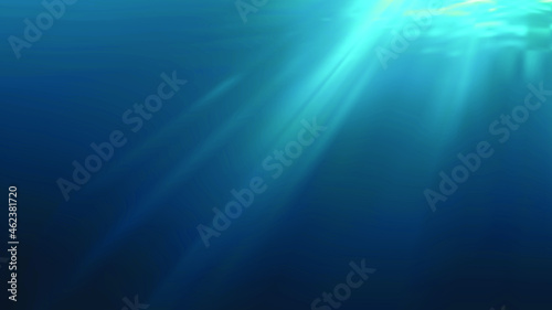 Sun rays and light shining through surface of ocean seen from underwater. © vchalup
