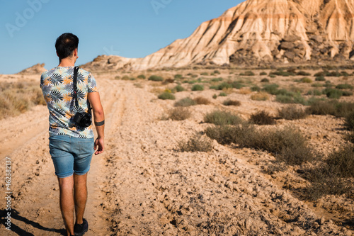 Young man with a camera in Bardenas Reales desert  Navarra  Basque Country.