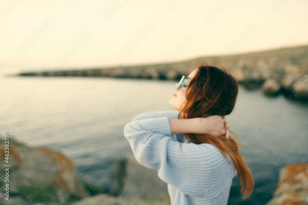 red-haired woman in sweater outdoors travel fresh air