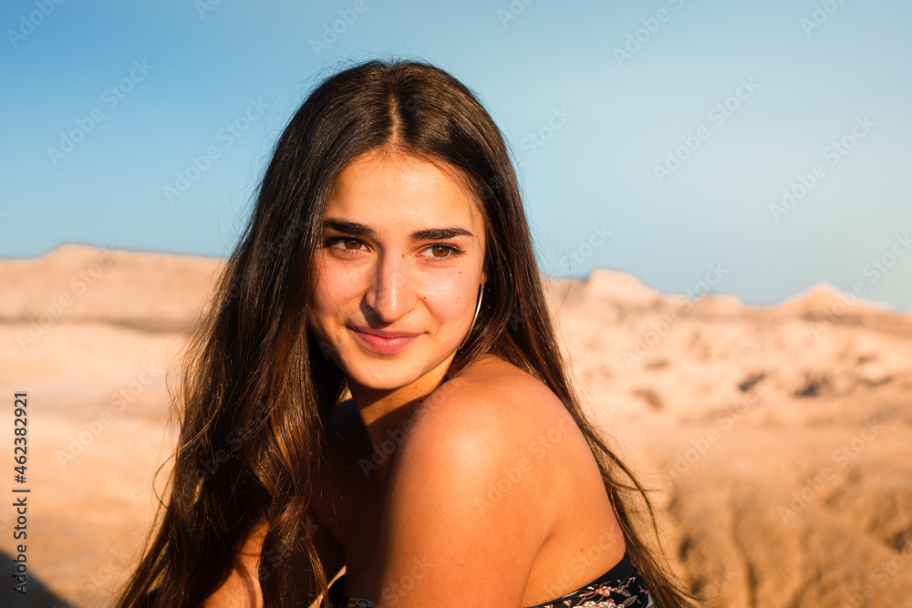 Young caucasian woman posing in Bardenas Reales desert at sunset time. Navarra, Basque Country. Young caucasian woman posing in Bardenas Reales desert at sunset time. Navarra, Basque Country.