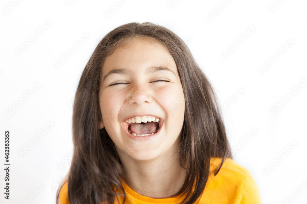Portrait of happy smiling kid girl in yellow T-shirt isolated on white background Portrait of happy smiling kid girl in yellow T-shirt isolated on white background