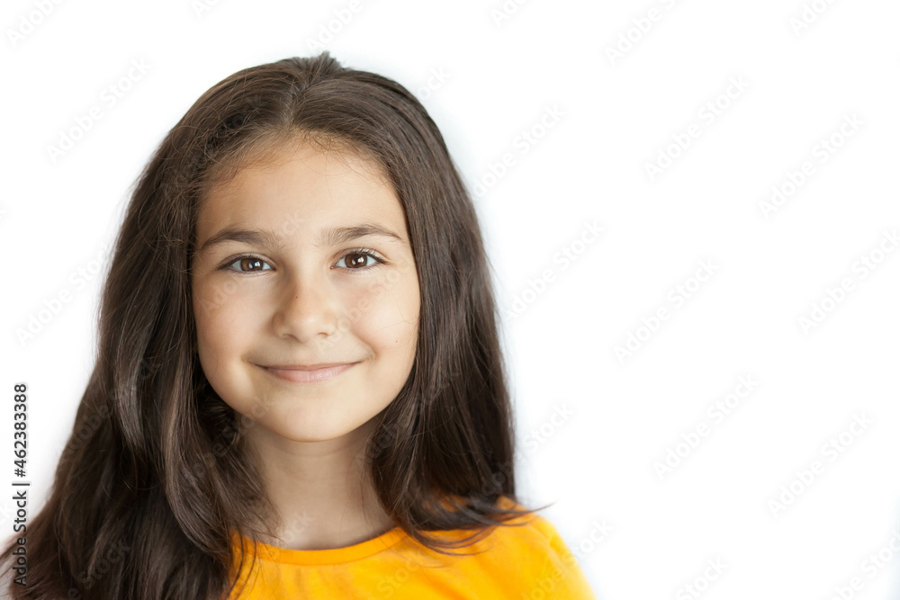 Happy positive smiling child girl with a long hair in yellow T-shirt isolated on white background Happy positive smiling child girl with a long hair in yellow T-shirt isolated on white background