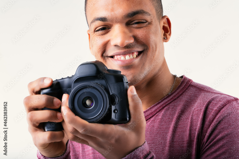 Smiling friendly male photographer holding his camera Smiling friendly male photographer holding his camera