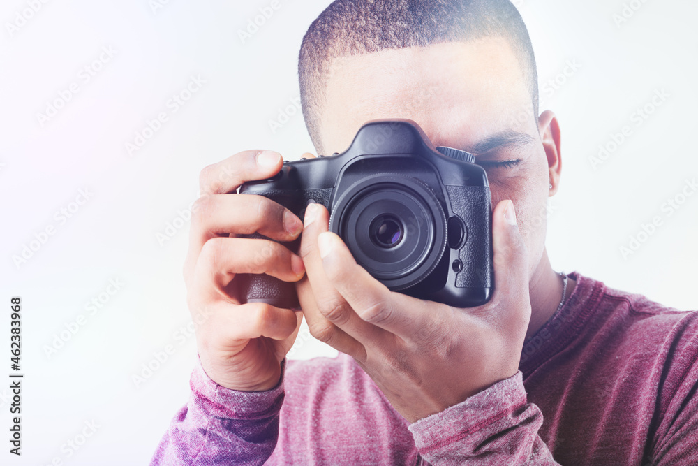 Fototapeta premium High key portrait of a Black male photographer with camera