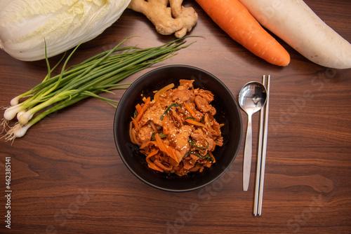 Stir fried kimchi with pork in a black bowl top view