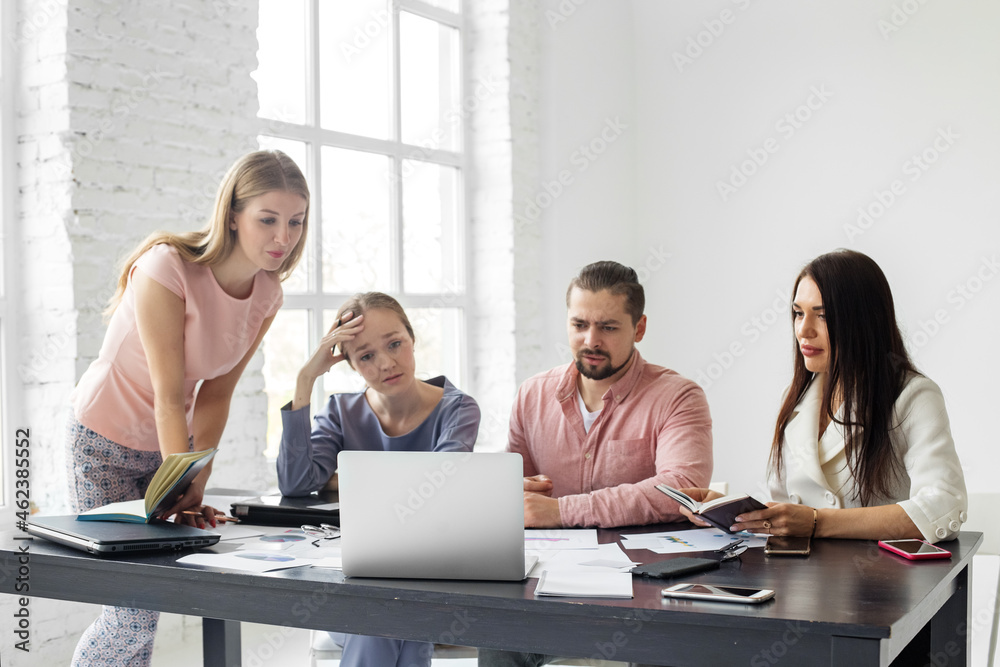Fototapeta premium Upset people from a business group. Saddened by poor work employees sitting at the table