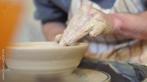 Potter making ceramic pot on the twisted pottery wheel.Potter at work, close up.