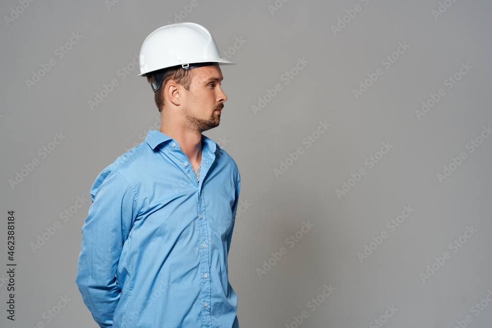 engineer in a white helmet construction industry light background