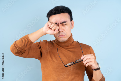 Asian man posing on blue background