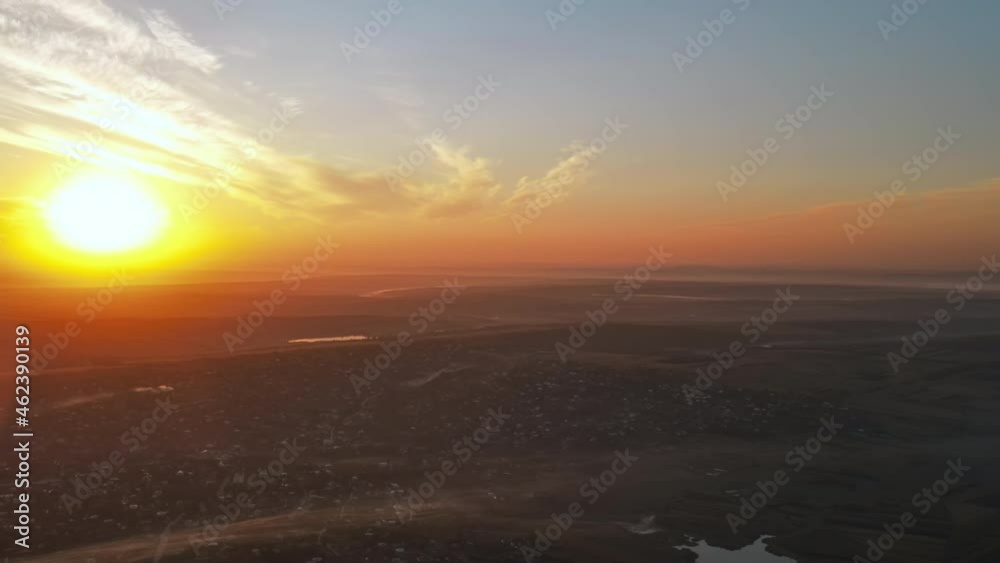 Aerial drone view of village in Moldova at sunset. Few columns of smoke from fires, wide fields Aerial drone view of village in Moldova at sunset. Few columns of smoke from fires, wide fields