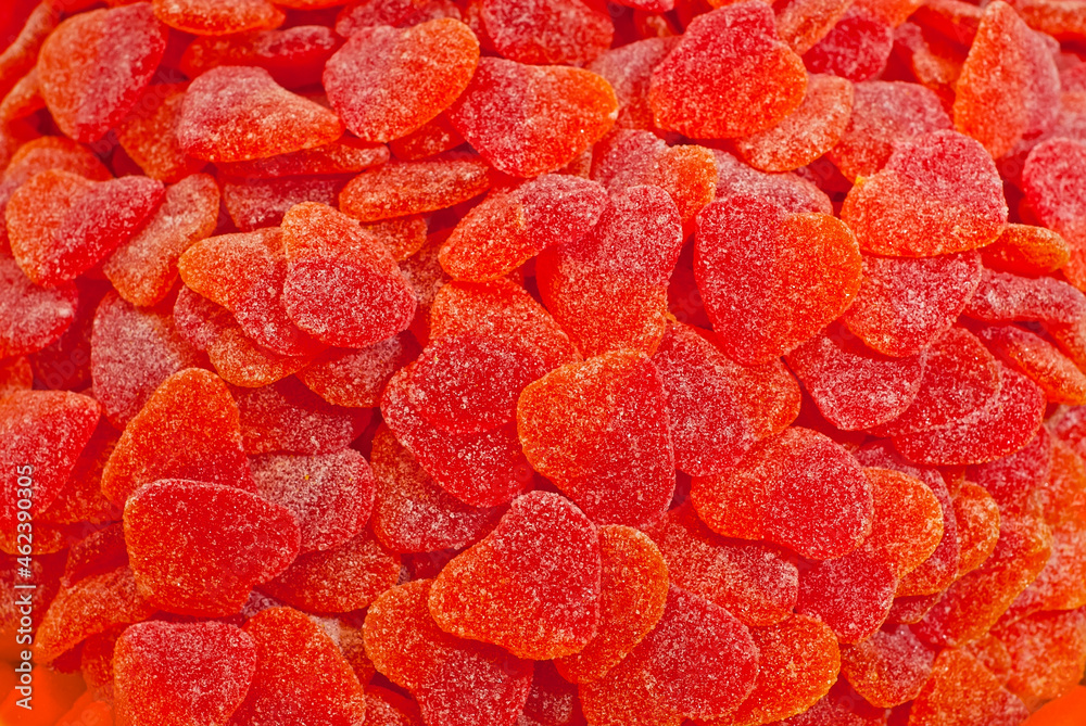 Texture of red and orange candies. Sweets on a pile close up. Sweets shop window. Texture of red and orange candies. Sweets on a pile close up. Sweets shop window.