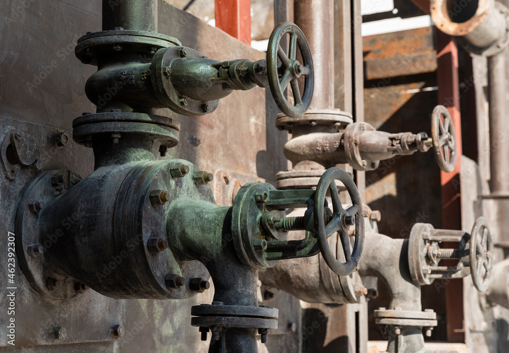 Old rusty valves of industrial oven from steam revolution times with pipes all in steampunk climate Old rusty valves of industrial oven from steam revolution times with pipes all in steampunk climate