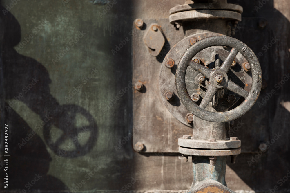 Old rusty valves of industrial oven from steam revolution times with pipes all in steampunk climate