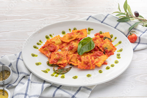 ravioli in tomato sauce with spinach leaf