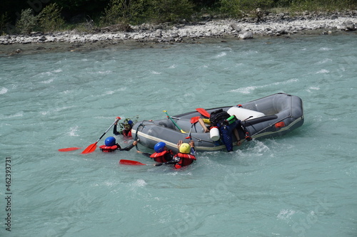 white river rafting accident everybody in the water trying to climb back up raft in durance river alps france photo