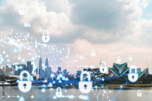 Hologram of padlock icons over panoramic city view of Kuala Lumpur to protect business, Malaysia, Asia. The concept of information security shields. Double exposure.