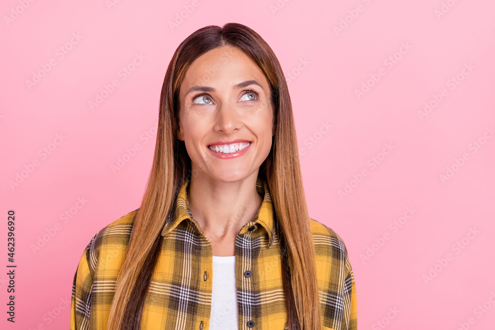 Photo of dreamy young happy woman smile good mood look empty space isolated on pastel pink color background Photo of dreamy young happy woman smile good mood look empty space isolated on pastel pink color background