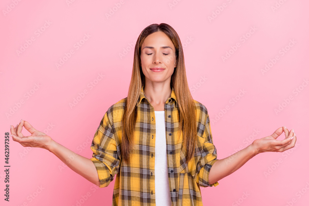 Photo of adorable positive lady closed eyes arms meditate wear checkered isolated on pink color background Photo of adorable positive lady closed eyes arms meditate wear checkered isolated on pink color background
