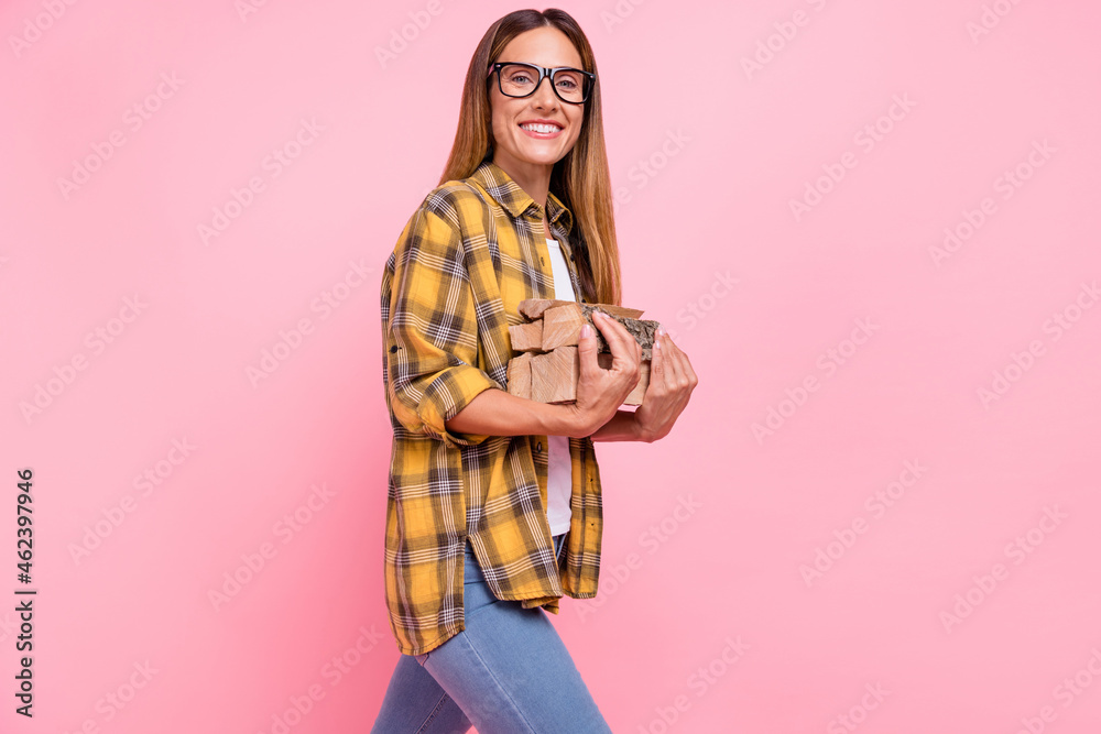 Photo of happy positive happy woman hold hands firewood cut good mood isolated on pink color background Photo of happy positive happy woman hold hands firewood cut good mood isolated on pink color background