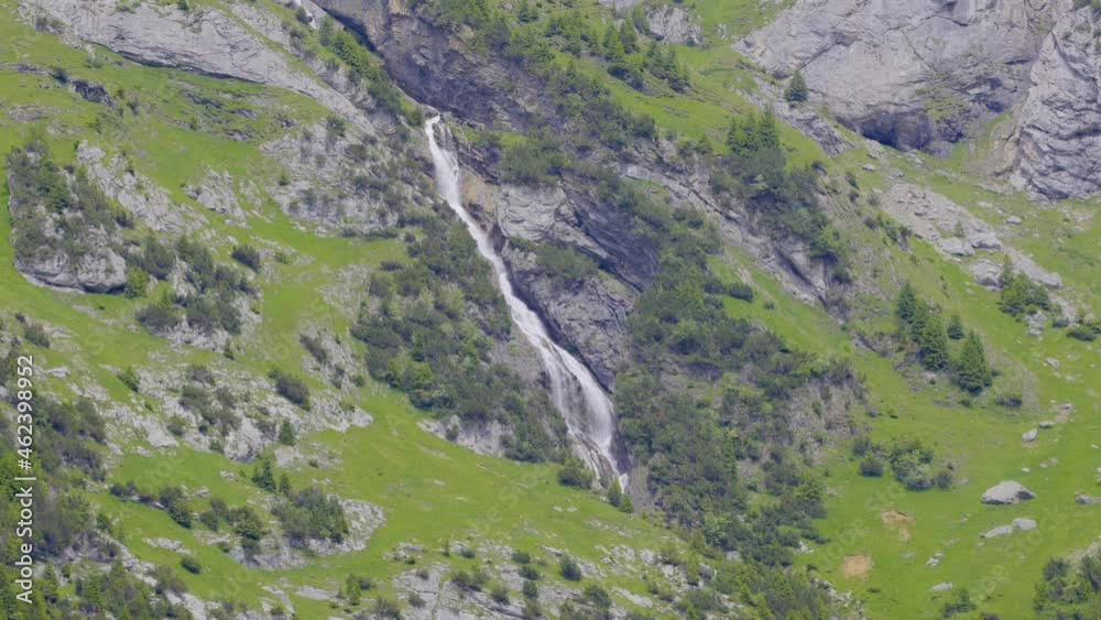 Waterfall in the mountains, Niemerstafelbach. Water falls from the rock high in the mountains near Unterschächen, Klausenpass, Canton Uri, Switzerland. Waterfall in the mountains, Niemerstafelbach. Water falls from the rock high in the mountains near Unterschächen, Klausenpass, Canton Uri, Switzerland.