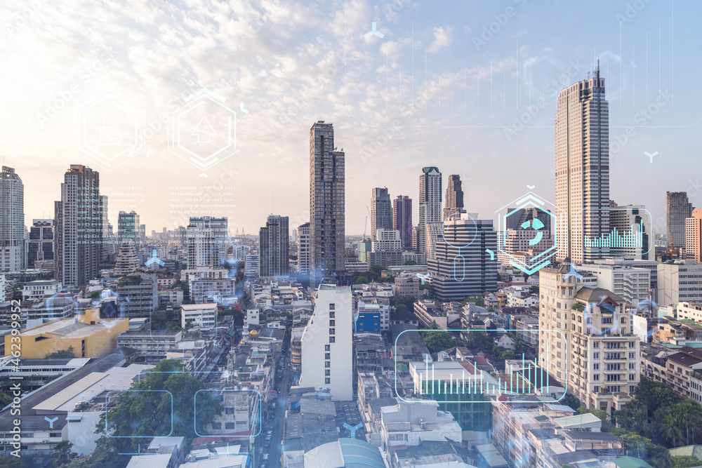 Fototapeta premium Glowing hologram of technological process, aerial panoramic cityscape of Bangkok at sunset. The largest innovative hub of tech services in Southeast Asia. Multi exposure.
