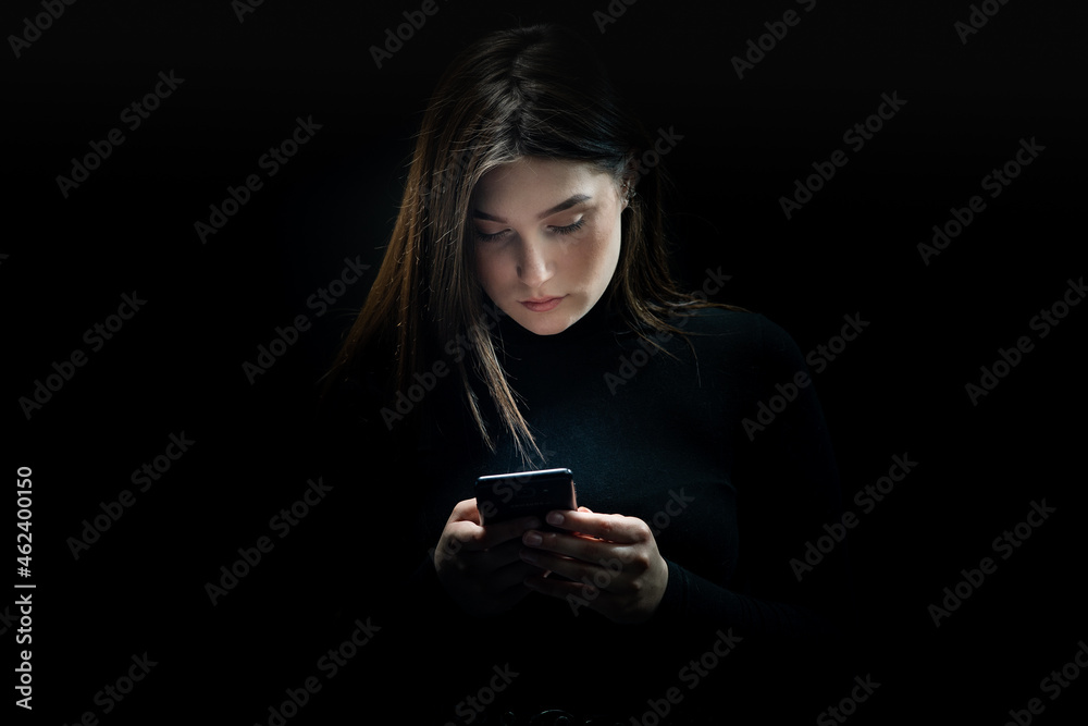 Girl and mobile with a black background Girl and mobile with a black background