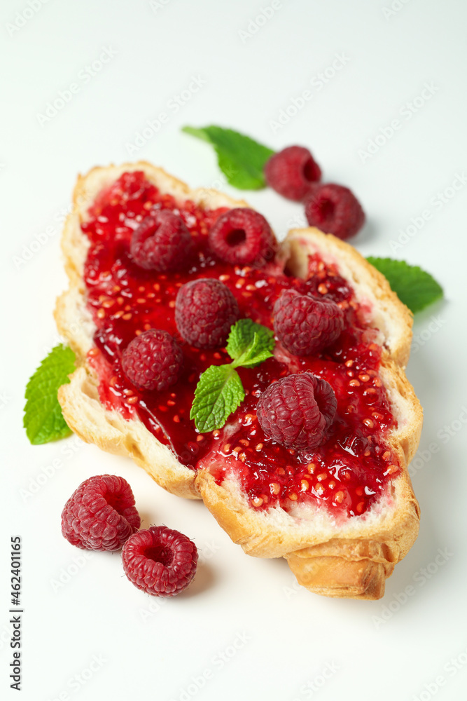 Croissant with raspberry jam on white background Croissant with raspberry jam on white background