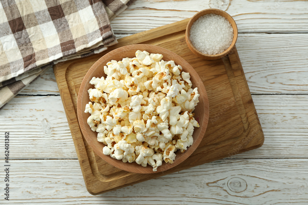 Concept of homemade salt popcorn on white wooden background Concept of homemade salt popcorn on white wooden background