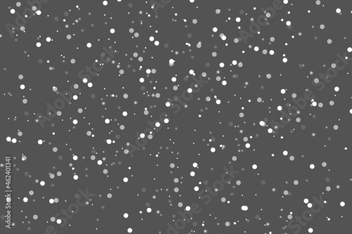 Abstract winter background from snowflakes blown away by the wind on  gray backdrop. White dust. Christmas background. Magic shining white dust. Fantastic shimmer effect