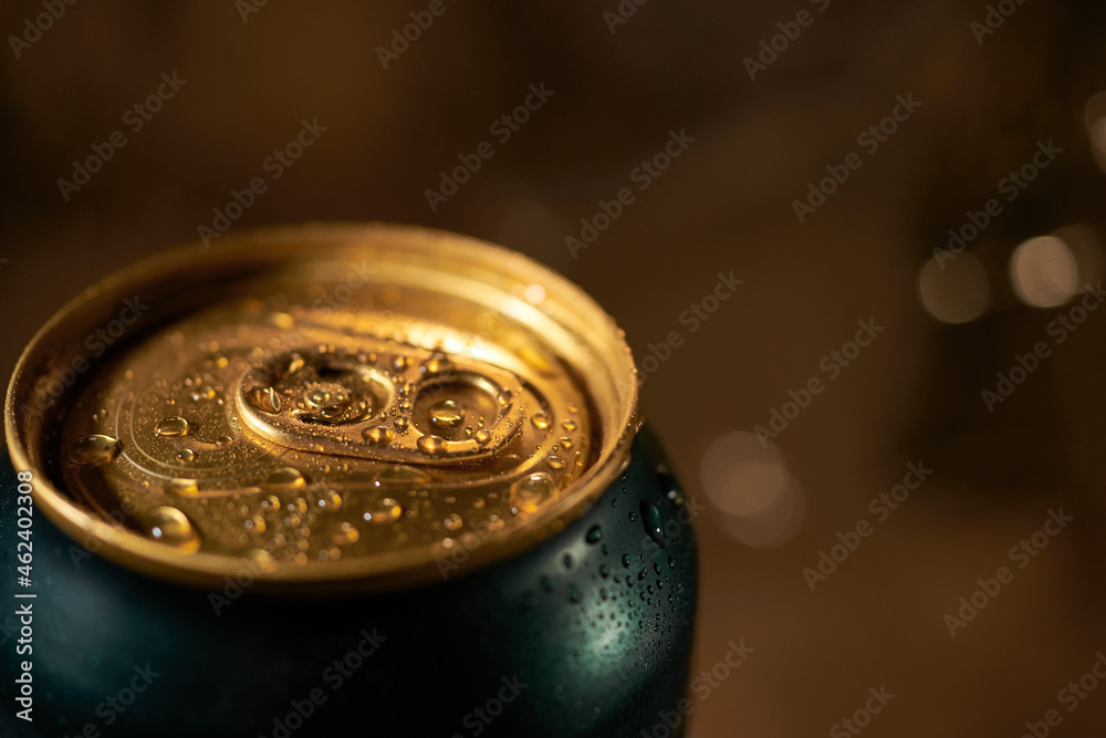 Close-up of golden beer can in a cozy bar light Close-up of golden beer can in a cozy bar light