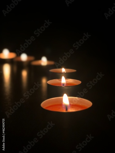 Beautiful burning candles. In a dark room.