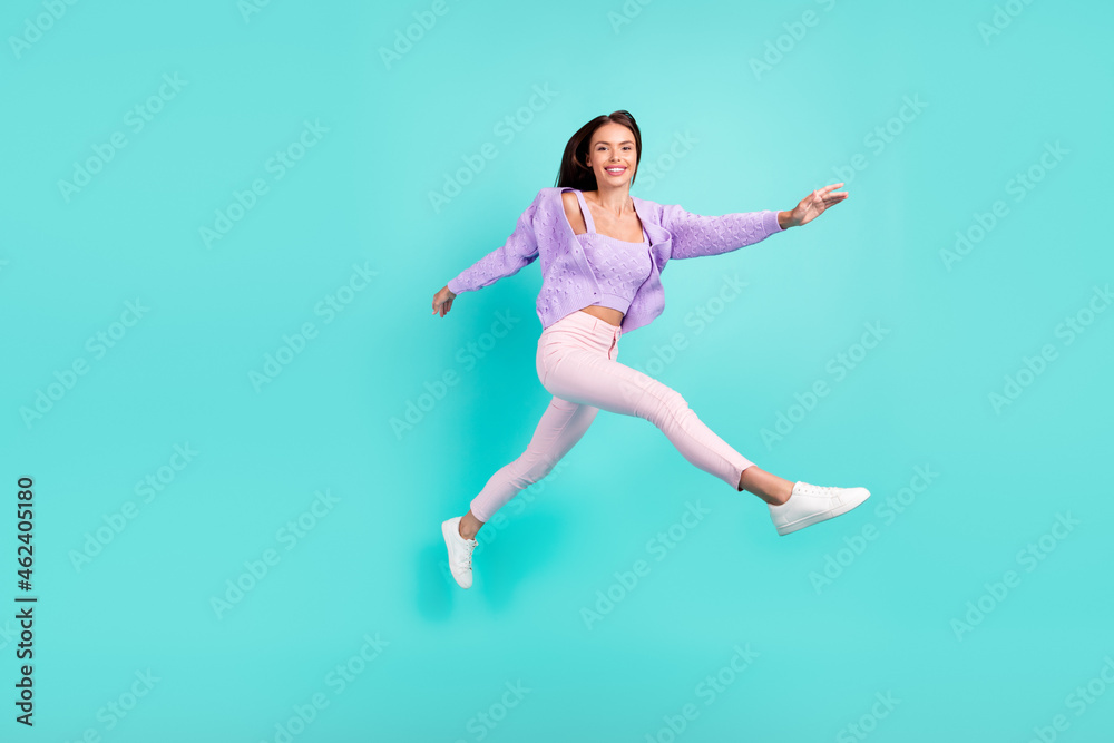 Photo of carefree inspired sporty lady jump run go wear purple cardigan pants shoes isolated turquoise color background