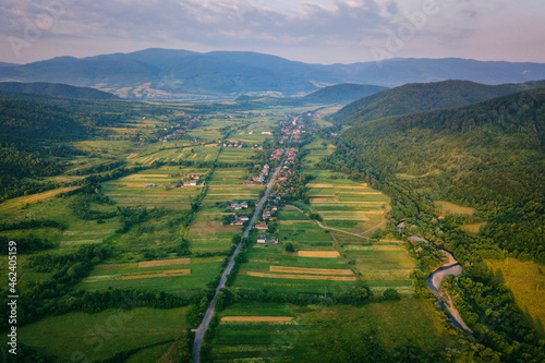 Aerial view of the narrow winding road through the beautiful wooded Carpathia...