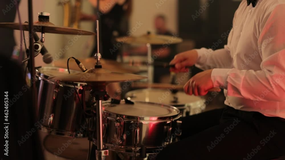 Rock Band Performing at a Concert in a Night Club. Drummer Playing the Drums. Live Music Party in Front of Bright Colorful Strobing Lights on Stage. Man Perform Jazz Songs at Nightclub Rock Band Performing at a Concert in a Night Club. Drummer Playing the Drums. Live Music Party in Front of Bright Colorful Strobing Lights on Stage. Man Perform Jazz Songs at Nightclub