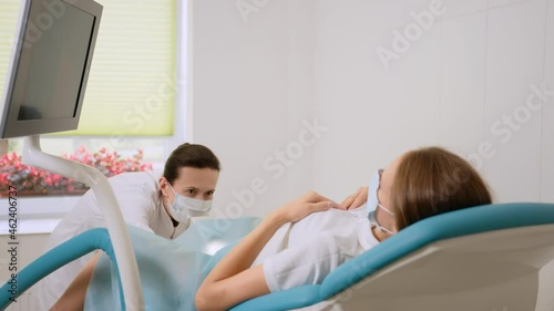 Female gynecologist in medical unifrom examining patient
