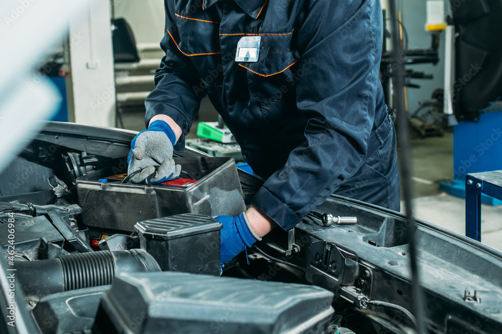 car service, an employee replaces and tests the car battery car service, an employee replaces and tests the car battery