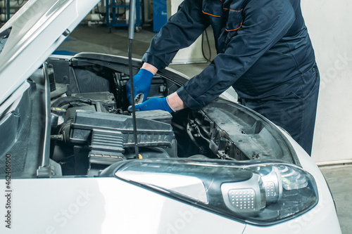 car service, an employee replaces and tests the car battery © Дмитрий Бесов