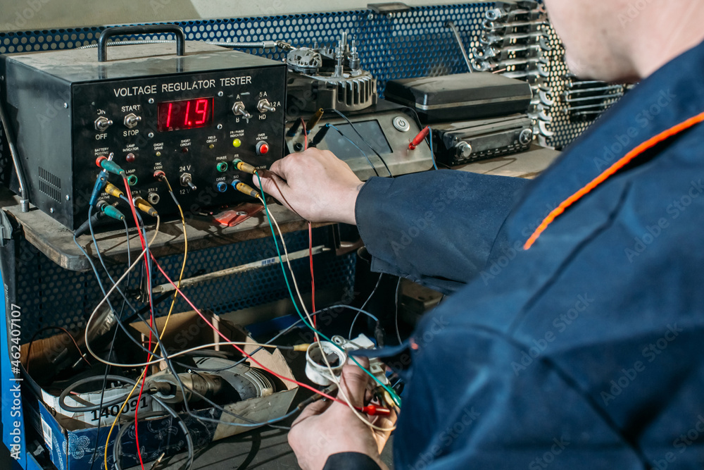 Obraz premium car service, an employee repairs and tests car parts