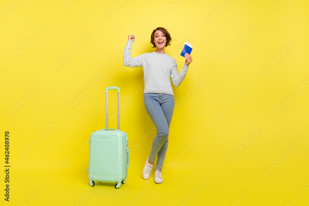 Full size photo of hooray millennial blogger lady with bag passport wear pullover jeans sneakers isolated on yellow background Full size photo of hooray millennial blogger lady with bag passport wear pullover jeans sneakers isolated on yellow background