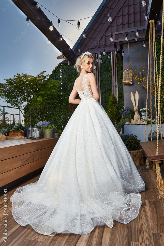 Fototapeta premium Sexy beautiful blonde woman pretty bride wedding big day marriage ceremony in summer garden wearing long silk and lace white dress bright makeup hairstyle pure love interior.