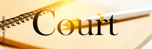 Court - a word on the background of a pen and notepad