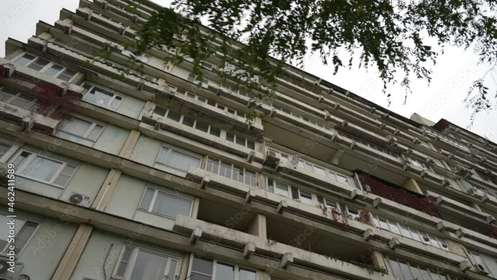 The facade of a high-rise residential building with unusual balconies. Unusual house. Bottom view. Dolly camera shot The facade of a high-rise residential building with unusual balconies. Unusual house. Bottom view. Dolly camera shot