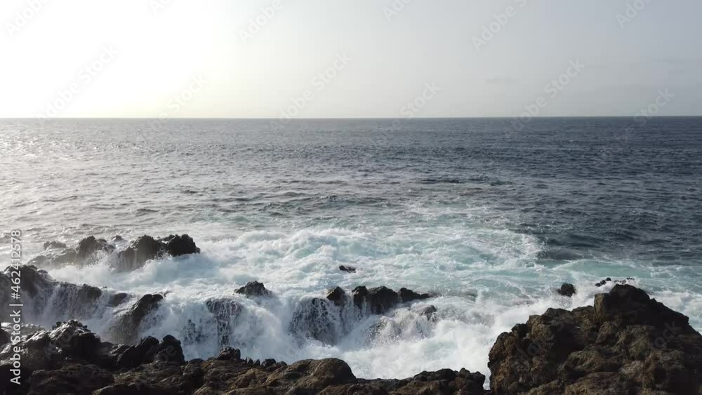 ocean waves on black stone , rough sea crashing on rocks ocean waves on black stone , rough sea crashing on rocks